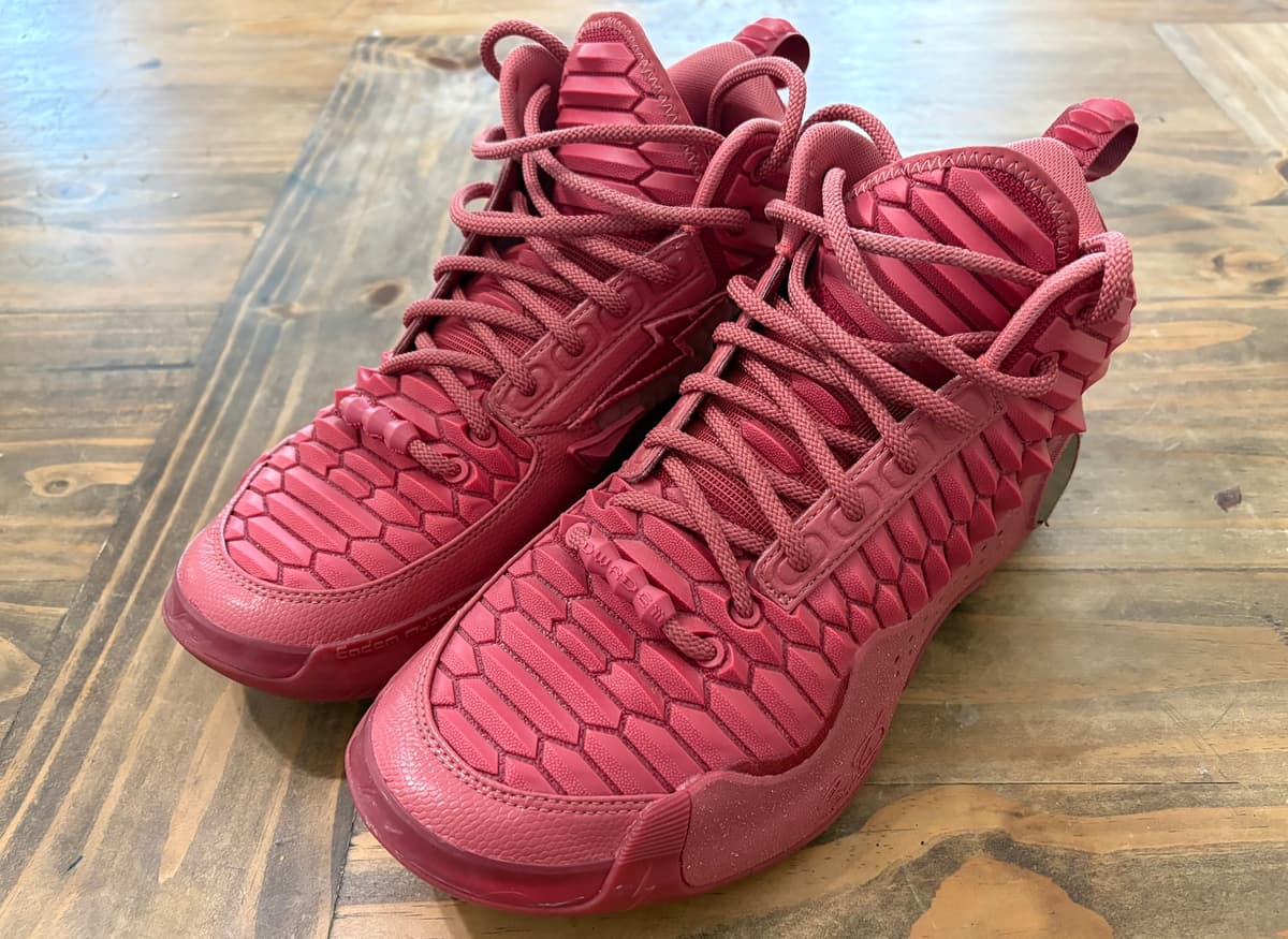 Way of Wade 10 Red Dragons in an all-red dragon-scale upper, sitting on a wooden table
